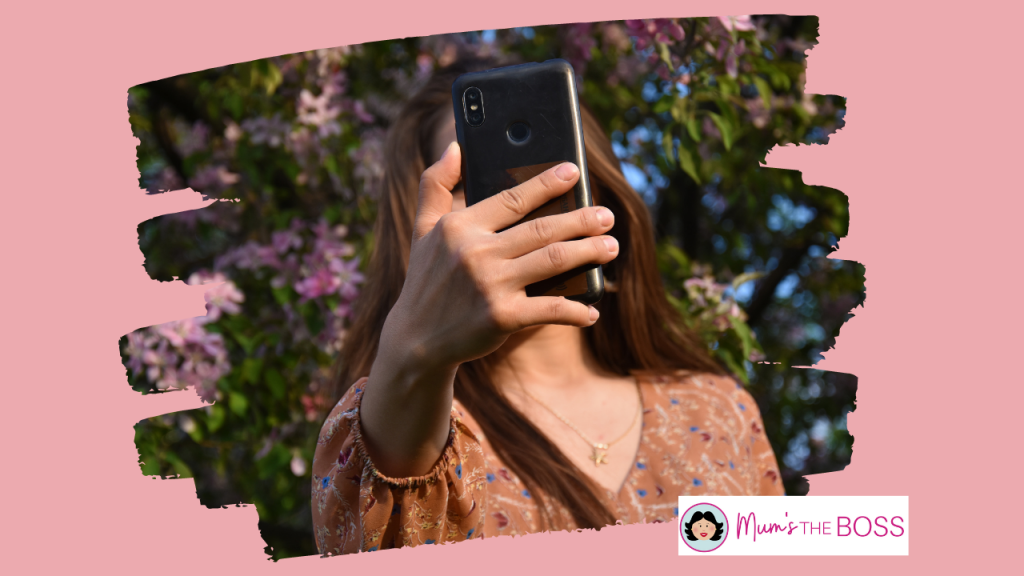 A woman is taking a selfie, however what we can see is her head but the phone is obscuring her face